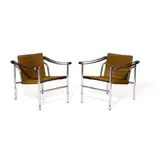 Pair of LC1 Basculant Chairs by Le Corbusier, Charlotte Perriand & Pierre Jeanneret, for Cassina, chromed metal, leather, cow hide, sold Jul 2023
