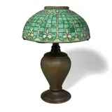 Fleur-de-Lys Lamp with Pine Needle Base by Tiffany Studios, leaded glass, patinated bronze, shade tag-stamped 'TIFFANY STUDIOS NEW YORK' with additional tag stamp '1438-2', sold Mar 2023