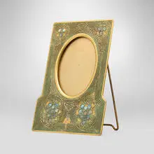 Abalone picture frame by Tiffany Studios, c. 1920, acid-etched and gilt bronze, mother-of-pearl, glass, sold Jul 2025