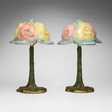 Pairpoint, Puffy boudoir lamps with roses, pair, c. 1915, reverse-painted frosted glass, patinated metal