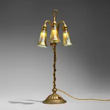 Adjustable three-light Lily lamp by Tiffany Studios, c. 1910, acid-etched and gilt bronze, hand-blown Favrile glass, sold Jul 2025