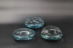 Per Lütken for Holmegaard, Two blue tinted blown glass ash trays and a similar bowl