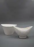 Two white slip-cast ceramic vases by Crown Lynn Potteries, sold Feb 2023