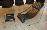 and matching footstool by Black leather upholstered sling chair, sold Jun 2016
