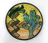 Warren Tippett, Stoneware plate painted to the well with a cactus and geometrical motifs, signed with painted initials, 1982.