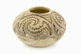 Wi Taepa, Squat globular vase with stained grey crackled glaze, decorated with carved Maori and geometrical designs.