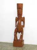 Pakariki Harrison, Carved kauri pouwhakairo figure. Modelled standing on plinth base with three-fingered hands to abdomen and red painted tamoko.