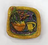 Rosemaire Brittain, Polychrome glazed terracotta dish, moulded with a jug and vase. Signed to base.