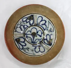 Marilyn Wiseman, Stoneware bowl with unglazed exterior and outside rim. The well with gestural floral decoration on a pale celadon ground.