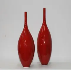 Two red glazed bottle vases by Peter Collis, sold May 2012