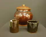 St Ives, Lidded stoneware jar, three plates and two small beakers