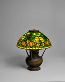 Crocus Table Lamp by Tiffany Studios, on Urn Base, leaded glass and patinated bronze, shade stamped 'TIFFANY STUDIOS NEW YORK', base stamped 'TIFFANY STUDIOS , sold Dec 2022