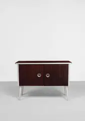 'BD1' cabinet by Ernest Race, circa 1946, Mahogany-laminated aluminium, mahogany-laminated Holoplast, aluminium, beech, sold Apr 2022