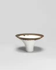 Lucie Rie, Flared bowl, circa 1970, Porcelain, matt white glaze with golden manganese lip