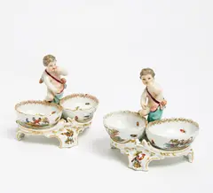 PAAR GEWÜRZGEFÄßE MIT PUTTEN by Kpm, Porzellan, farbig und gold staffiert, sold Jan 2016