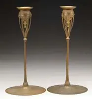 Candlesticks by Tiffany Studios, Gilded bronze with leaf ending supports to the candle cup, sold Dec 2006