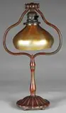 Desk Lamp by Tiffany Studios, Lamp begins with a tall bronze harp base with fluted bottom on five ball feet, sold Jun 2008