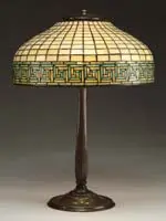 Greek Key Table Lamp by Tiffany Studios, Shade rests on a simple bronze stick base with three light cluster, sold Jun 2006