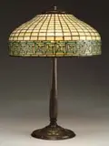 Greek Key Table Lamp by Tiffany Studios, Shade rests on a simple bronze stick base with three light cluster, sold Jun 2006