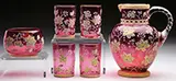 Mary Moser, Decorated Water Set, Moser cranberry glass water set consists of a pitcher, four tumblers and a bowl