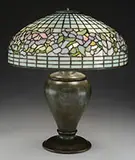 Belted Dogwood Table Lamp by Tiffany Studios, All set against a mottled light blue opalescent glass geometric background, sold Nov 2015