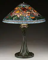 Tiffany Studios, Poppy Table Lamp, Mottled background glass shows lavender and fiery orange when lit