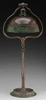 Table Lamp by Tiffany Studios, The base supports a Tiffany Studios bronze shade with acid etched openwork skirt, sold Jun 2017
