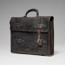 Marilyn Levine, Hanging Black Briefcase with Missing Strap, 1983, hand-built and glazed stoneware, metal