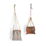 Two Hanging Vessels by Betty Woodman, partially glazed earthenware, string, leather, sold Oct 2021
