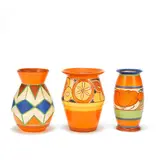 Clarice Cliff, 'Lily' vase from the 'Fantasque' series, 'Original Bizarre' and 'Sliced Fruit' vases from the 'Bizarre' series, early-mid 1930s, Glazed earthenware, painted designs
