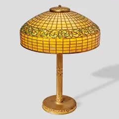 Tiffany Studios, Swirling Leaf Table Lamp, leaded glass, gilt bronze, shade stamped 'TIFFANY STUDIOS NEW YORK 1470', base stamped 'TIFFANY STUDIOS NEW YORK 528'
