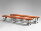 Raymond Subes, Pair of Benches, wrought iron, with martelé finish, each resting on a triple base in double cradle