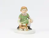 Kleiner Junge mit Lokomotive by Meissen, 20.Jh, Porzellan, farbig staffiert, sold Nov 2022
