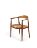 The Chair by Hans J. Wegner, for Johannes Hansen, teak, cane, stamped with maker's mark on underside, sold Oct 2019