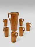 Alexandre Noll, Pitcher and Cups, mahogany, comprising pitcher and six cups, each engraved 'ANOLL'