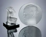 René Lalique, An Early Post-War 'Floreal' Statuette and a 'Pasteur' Plaque, designed in 1942 and 1922