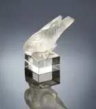 A 'Moineau Sur Socle, Ailes Croisées' Paperweight, designed in 1929 by René Lalique, clear glass, mould-blown, frosted and polished, offered Feb 2019