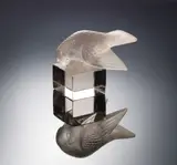 A 'Moineau Sur Socle, Ailes Ouvertes' Paperweight, designed in 1929 by René Lalique, the glass of faint amethsyt hue, moulded, frosted and polished, offered Feb 2019