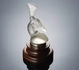 A 'Tête de Paon Car Mascot, designed in 1928 by René Lalique, clear glass, mould-blown, frosted and polished, seated in a chromed metal mount on a turned wood base, sold Feb 2019