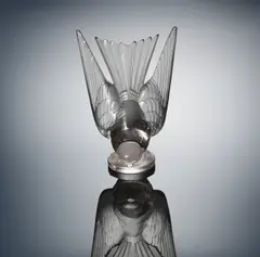 René Lalique, A 'Hirondelle' Car Mascot, designed in 1928, the glass of faint amethyst hue, mould-blown, frosted and polished