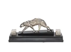Maurice Prost, A Stylish Art Deco Desk Tidy Panther, circa 1925, silvered bronze and glass, the panther positioned between two hinge-lidded glass inkwells, raised off a black marble plinth with pen tray