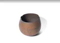A Vase by John Ward, circa 1990, stoneware of partly compressed form, in dark blue and rust tones, sold Jun 2019