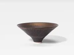 Dame Lucie Rie, A Conical Bowl, circa 1980, porcelain, covered in manganese with vertical incised lines to the interior and exterior