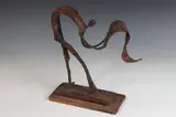 Robert Edward Kuhn, Figure Unfurling Rug, Bronze with rust and bronzed patina