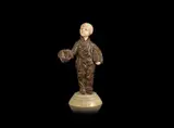 Demetre Chiparus, a Patinated Bronze and carved Ivory Study of a Child with Accordion
