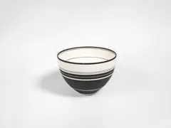 A Banded Bowl by Nicholas Homoky, circa 1994, porcelain, inlaid and painted with slip, creating monochrome bands in varying width, sold Jun 2018