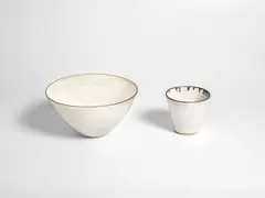 Dame Lucie Rie, A Bowl and Beaker, circa 1960, stoneware, in oatmeal glazes with manganese rims
