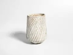 A Vase by Lucie Rie, circa 1960, stoneware, cream glaze with iron speckle, the gently tapered cylindrical body with deep spiral fluting, sold Jun 2018