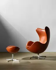 Arne Jacobsen, Egg Chair and Ottoman, for Fritz Hansen, cast aluminum, re-upholstered in leather, underside of aluminum pedestal stamped 'S'
