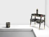Gio Ponti, and Piero Fornasetti, A desk designed c.1950 decorated with the 'Coromandel' pattern introduced in the 1960's, Lithographed wood, mahogany, bakelite and brass, with maker's disc to one drawer 'Fornasetti Milano'